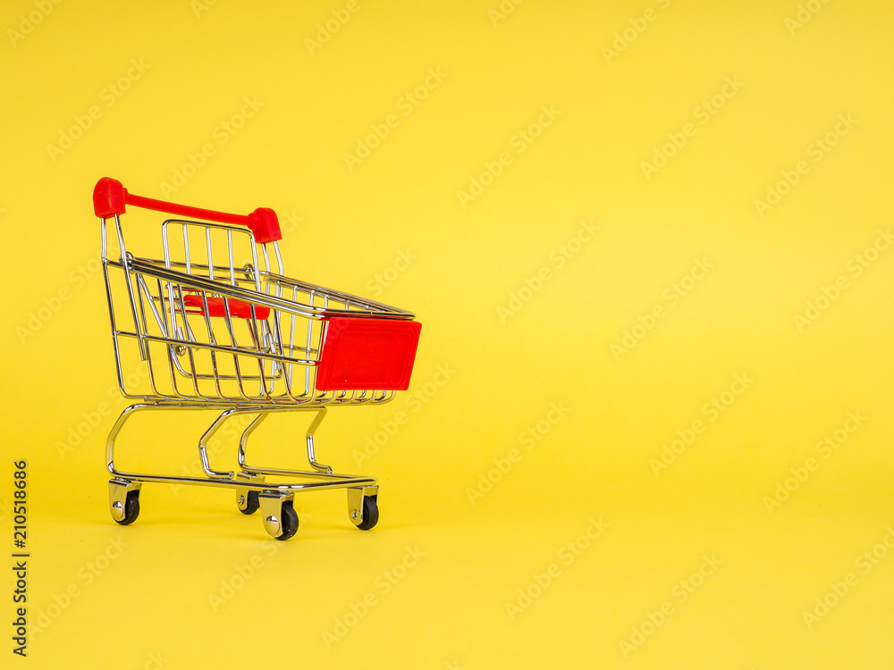 supermarket trolley on yellow background, empty, Concept of shopping. Copy space for advertisement. supermarket trolley on yellow background, empty, Concept of shopping. Copy space for advertisement.