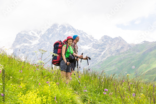 Hiking in beautiful mountains. Group of hikers enjoy sunny weather