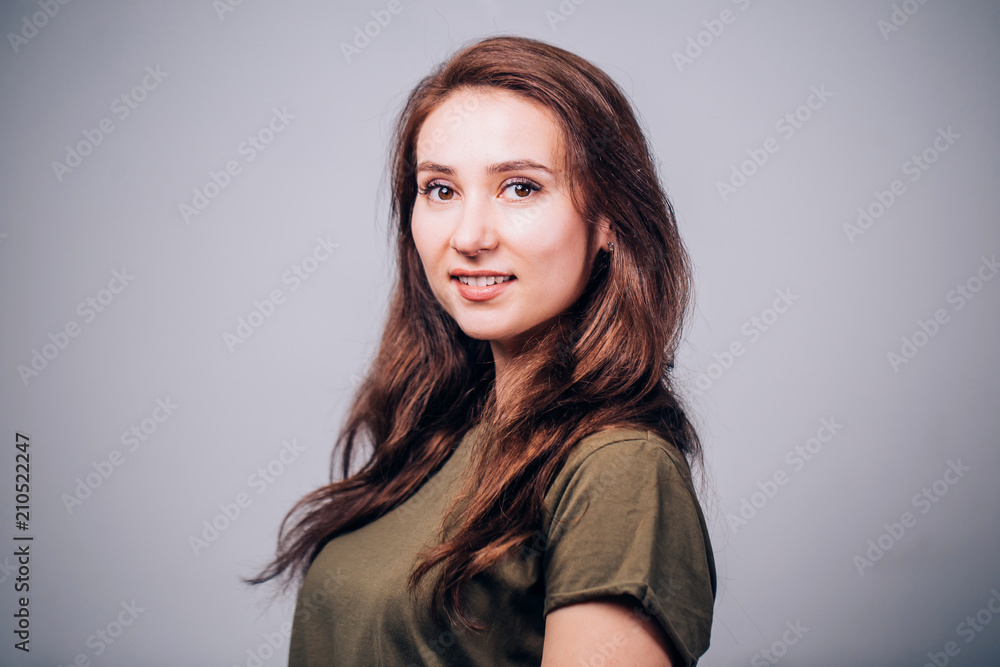 Happy cheerful young woman looking at camera with joyful and charming smile. Happy cheerful young woman looking at camera with joyful and charming smile.