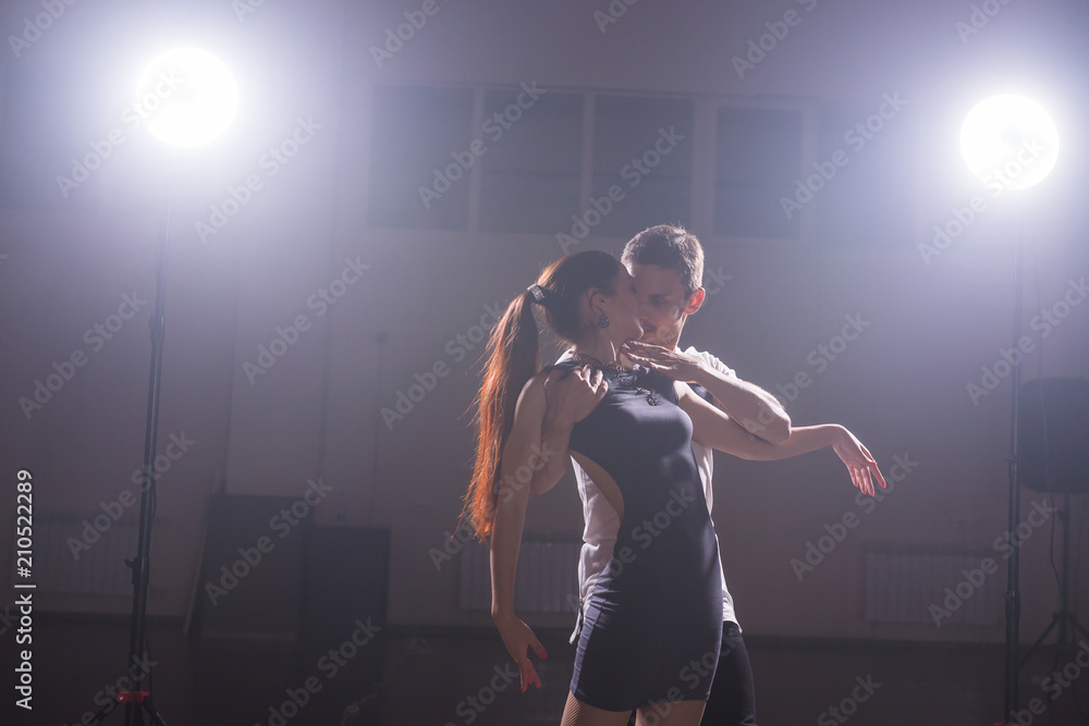 Young couple dancing social danse kizomba or bachata or semba or taraxia in dancing class background Young couple dancing social danse kizomba or bachata or semba or taraxia in dancing class background