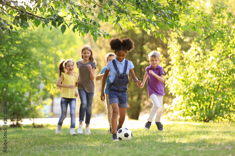 Cute little children playing with ball outdoors on sunny day