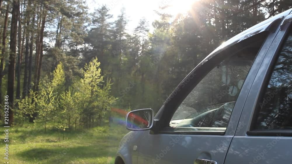 A man throws a plastic bottle out of a car window, pollution of nature by rubbish A man throws a plastic bottle out of a car window, pollution of nature by rubbish