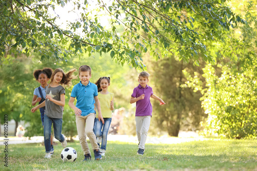 Cute little children playing with ball outdoors on sunny day