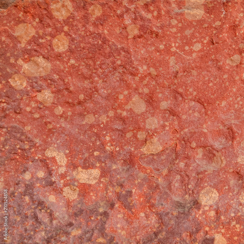 Red rough stone texture background. Material construction and architectural detail.