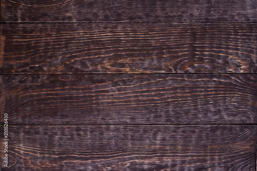 Grunge wooden background of dark horizontal brushed boards.