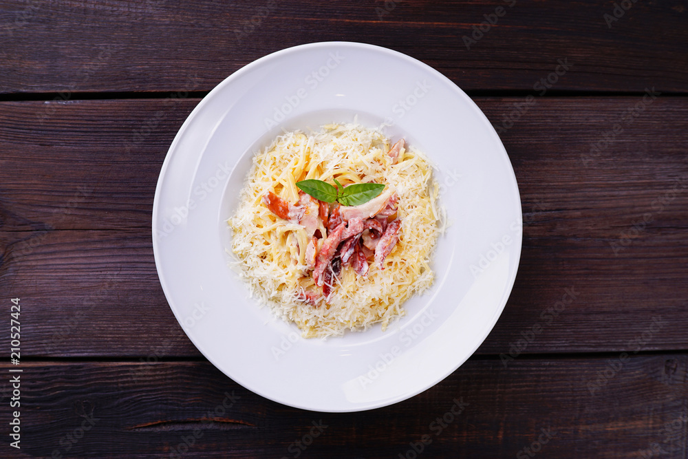 Pasta carbonara with ham and parmesan cheese. Traditional Italian meals, restaurant menu concept Pasta carbonara with ham and parmesan cheese. Traditional Italian meals, restaurant menu concept