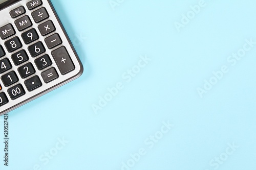 Business, finance, savings money, investment, taxes or accounting concept : Calculator on blue background with copy space ready for adding or mock up