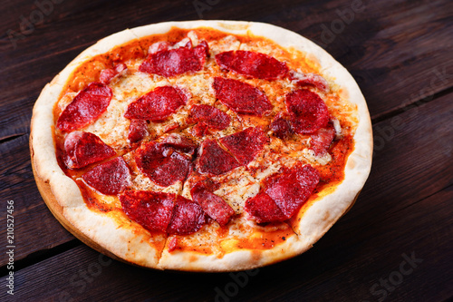 Classical sliced appetizing pepperoni pizza close up. Traditional Italian cuisine, popular snack. Food delivery, pizzeria, recipe, restaurant concept