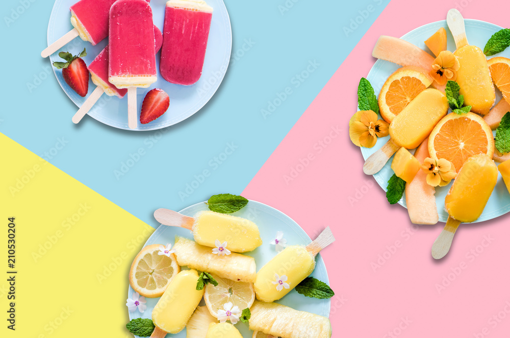Fotografie Fruit popsicles ice cream on pastel background, flat lay design
