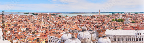View over Venice and its different quarters / Architecture, rooftops and houses of Venice in Italy seen from St. Mark's Tower