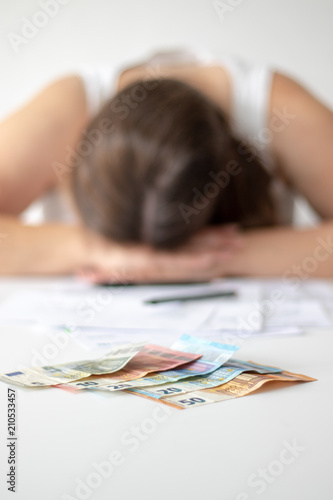 Erschöpfte Frau sitzt hinter dem Schreibtisch in der Bank