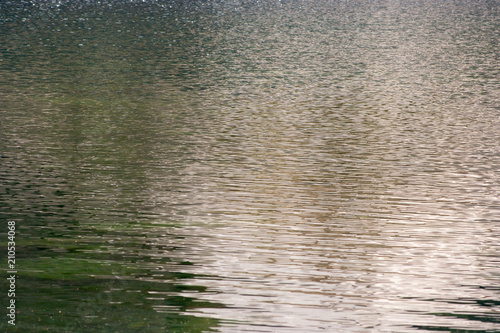Water mirror in the lake. Small waves forming in a mountain lake.