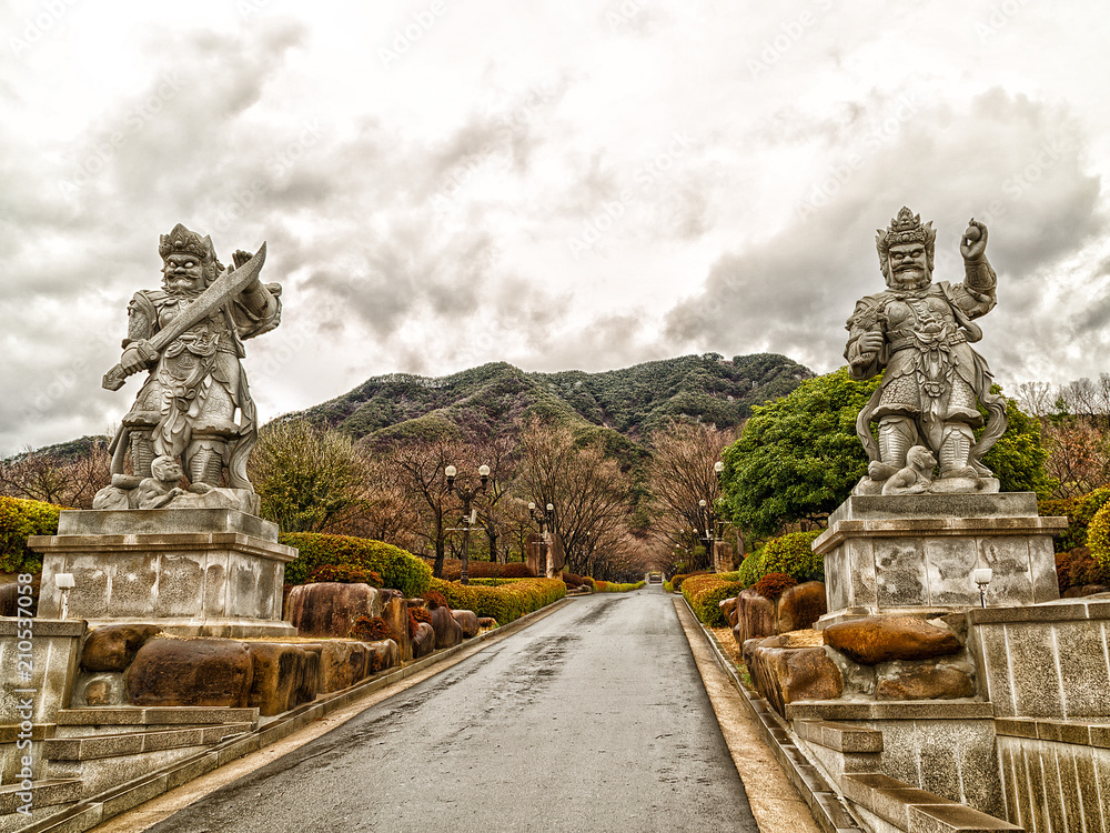 Fototapeta premium Alley in the misty mountains, guarded by Korean demons