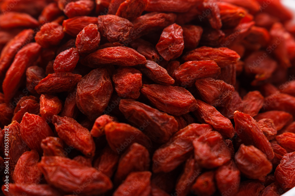 dried goji berries on a wooden rustic background dried goji berries on a wooden rustic background