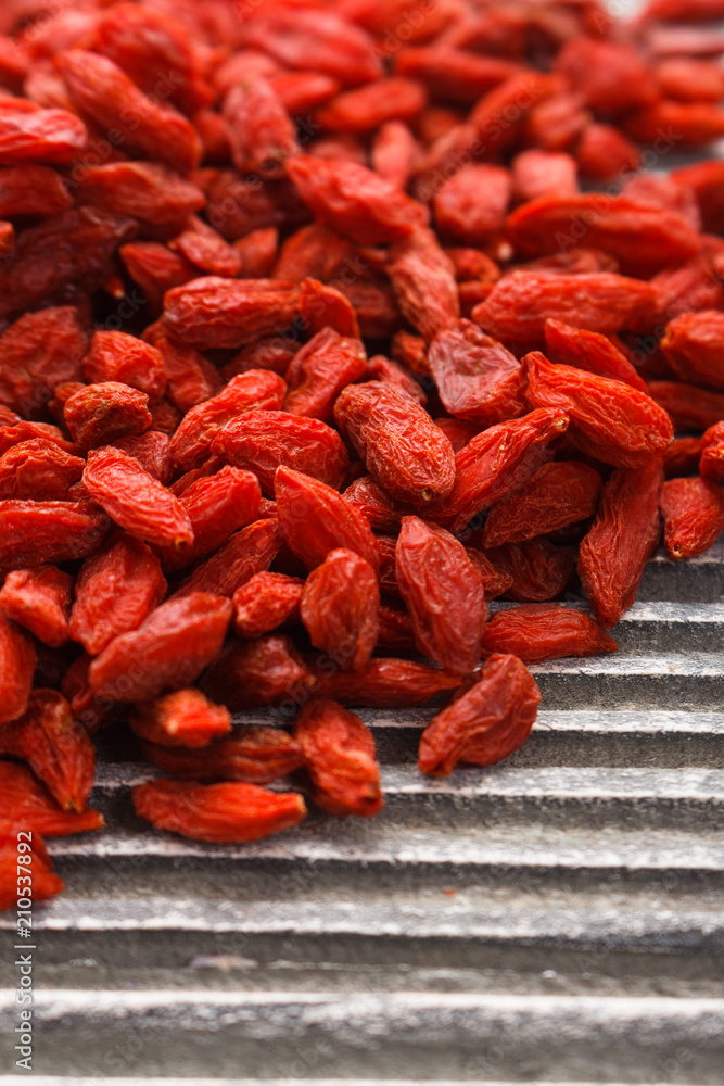 dried goji berries on a wooden rustic background dried goji berries on a wooden rustic background