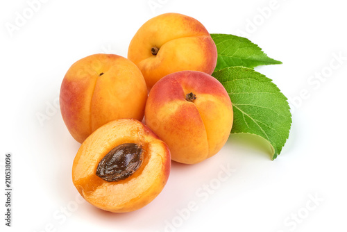 Fresh whole apricots with leaf and half with core, isolated on white background.