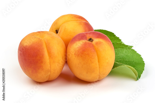 Fresh whole apricots with leaf, isolated on white background.