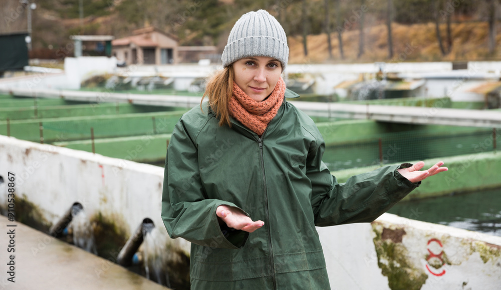 Naklejka premium Female showing fish tanks on sturgeon farm