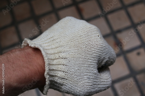 Hand in working gloves
