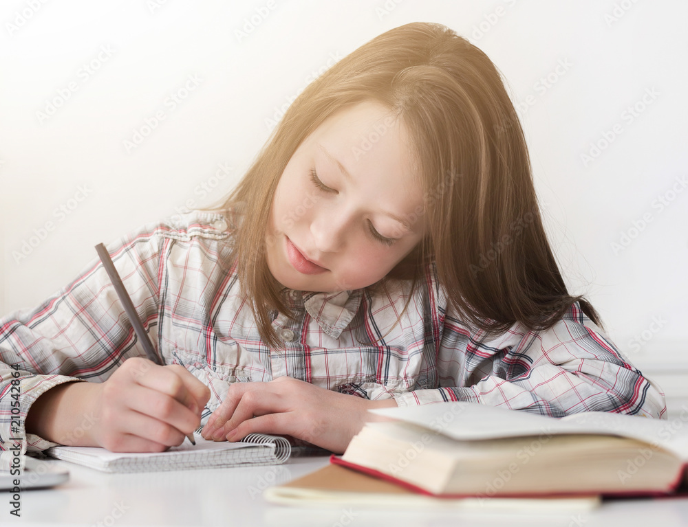 Portrait of concentrated teenage girl writing homework Portrait of concentrated teenage girl writing homework