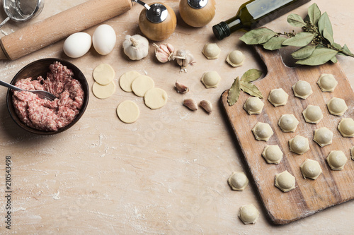 Raw homemade dumplings at cutting board