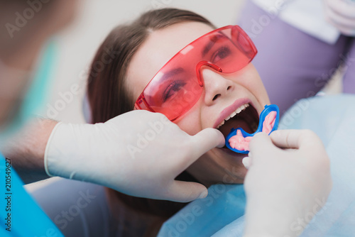 Fototapeta Naklejka Na Ścianę i Meble -  doctor orthodontist performs a procedure for cleaning teeth