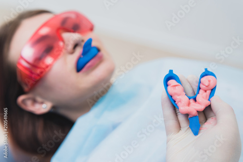 doctor orthodontist performs a procedure for cleaning teeth