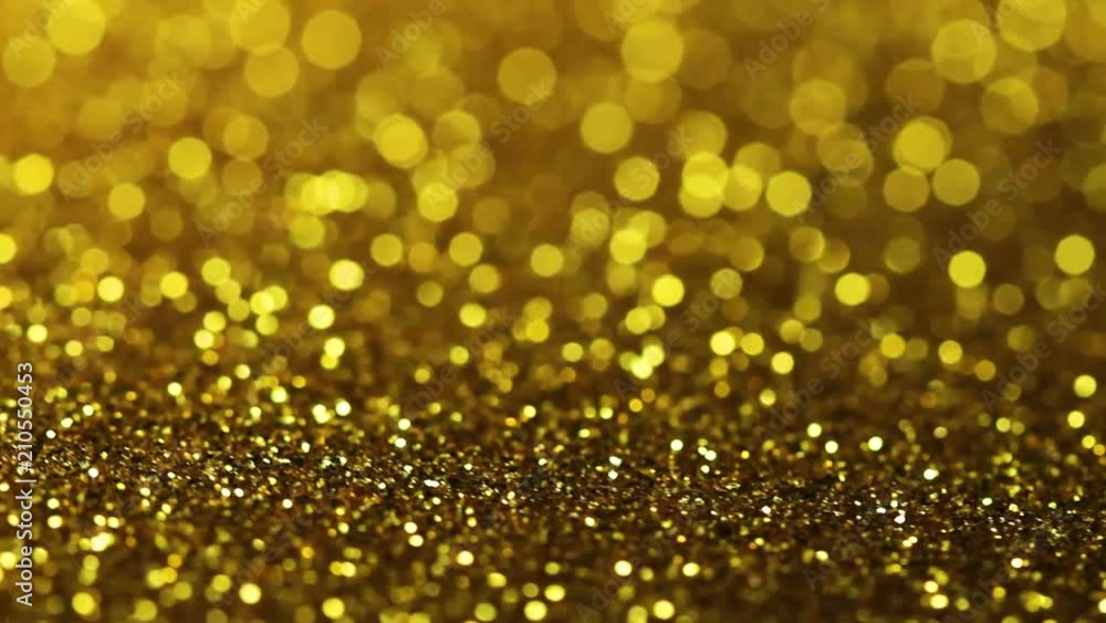Gold glitter texture rotating. Shiny abstract background.