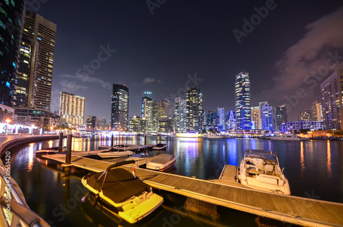 skyline of Dubai Marina at night with boats, United Arab Emirates photo