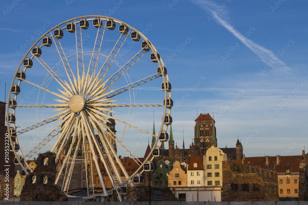Ferris wheel on the background of the beautiful city of Gdansk. Poland