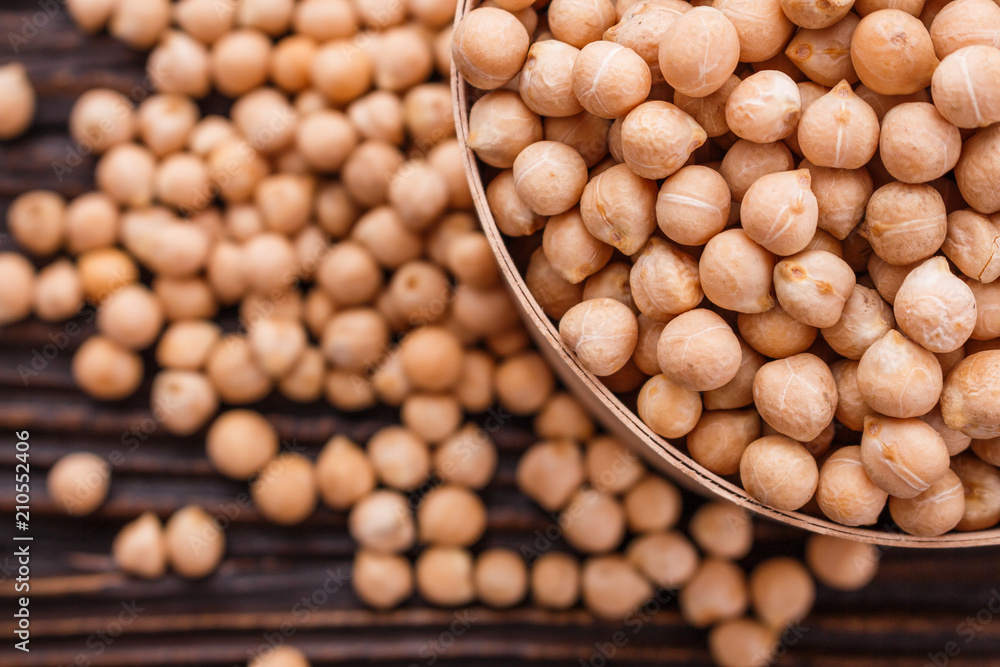 uncooked chickpeas on a wooden rustic background uncooked chickpeas on a wooden rustic background