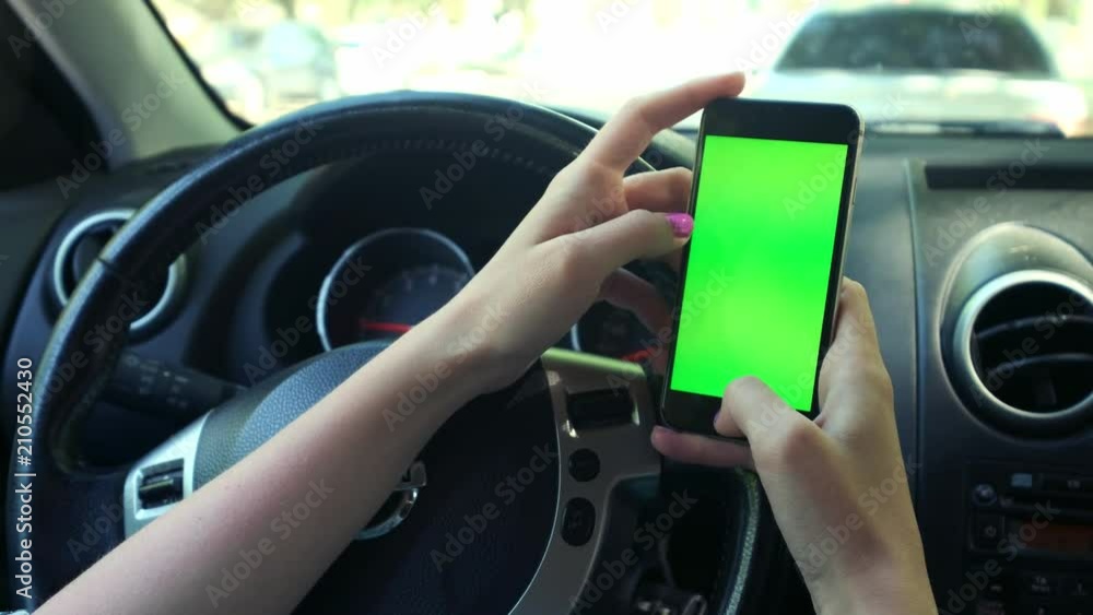Girl Driver closeup, greenscreen in the car, urban city background greenscreen chrome key 4k. Sweeps his hand across the screen to the down Girl Driver closeup, greenscreen in the car, urban city background greenscreen chrome key 4k. Sweeps his hand across the screen to the down