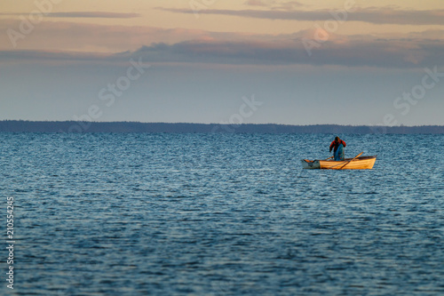 Fisherman in his small boat on the ocean