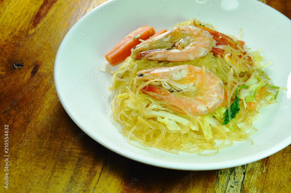 stir fried glass noodles with cabbage and egg topping shrimp on white plate stir fried glass noodles with cabbage and egg topping shrimp on white plate