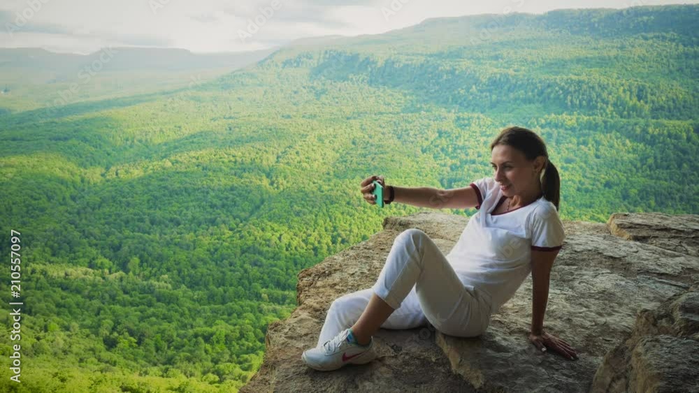 Summer Vacation, Tourism. Girl makes Selfi on Rock Summer Vacation, Tourism. Girl makes Selfi on Rock
