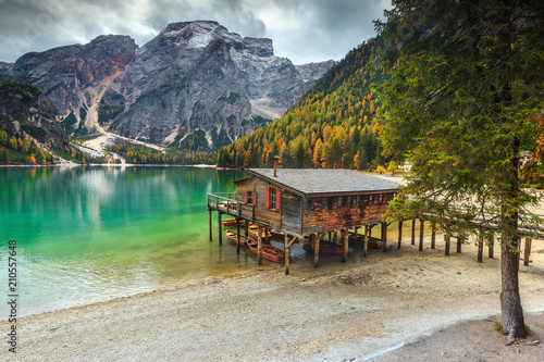 Fotobehang Wonderful wooden boathouse on the alpine lake, Dolomites, Italy, Europe