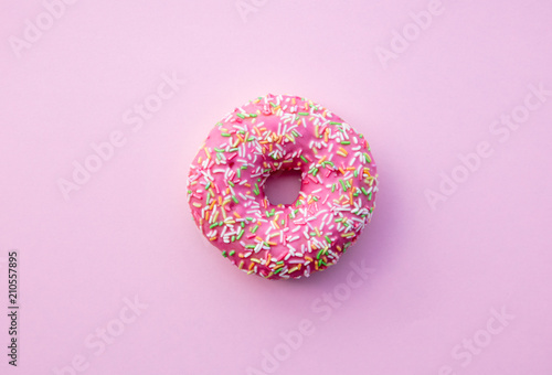 Fresh sweet donut on pink background. Abive view