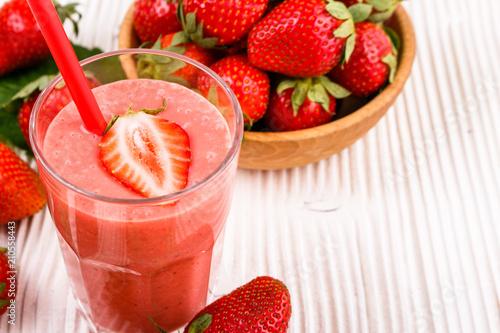 fresh strawberrysmoothie or milkshake on a wooden rustic background photo