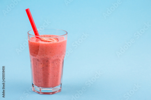 fresh strawberrysmoothie or milkshake on a delicately blue background