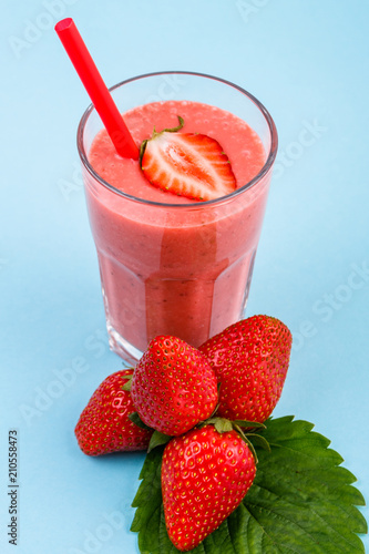 fresh strawberrysmoothie or milkshake on a delicately blue background photo