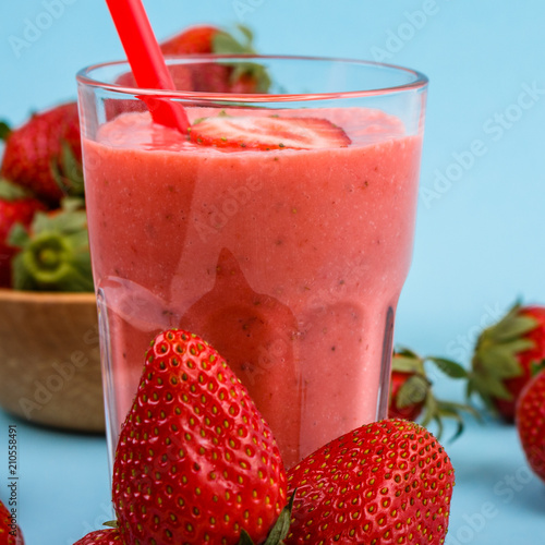 fresh strawberrysmoothie or milkshake on a delicately blue background photo