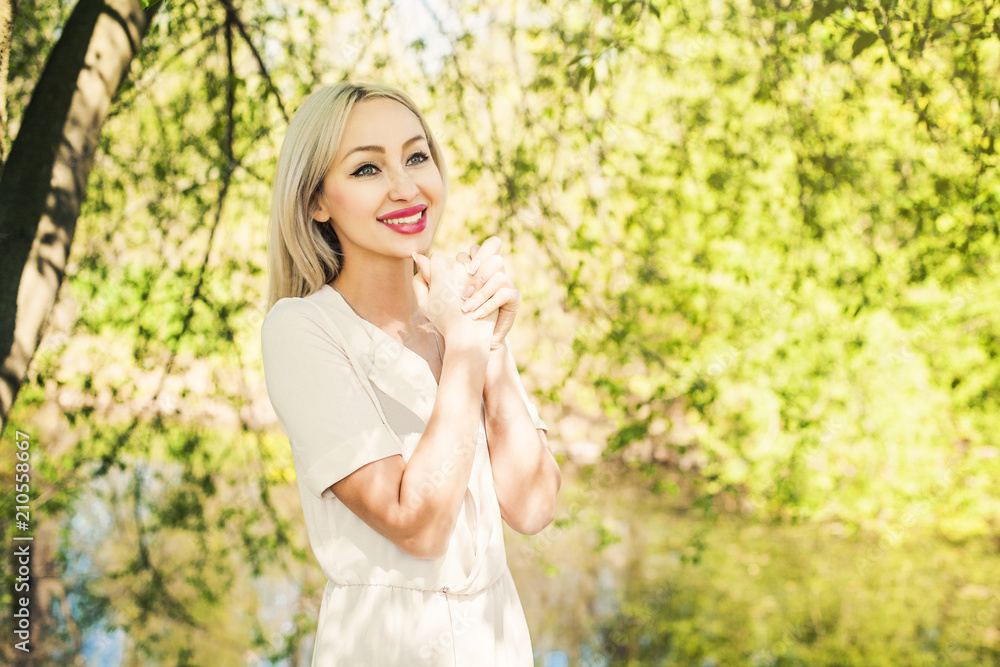 Laughing woman having fun outdoors on green foliage leaves background Laughing woman having fun outdoors on green foliage leaves background