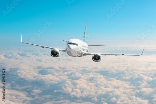 Passenger airplane is climbing high flight level in the sky above the clouds.