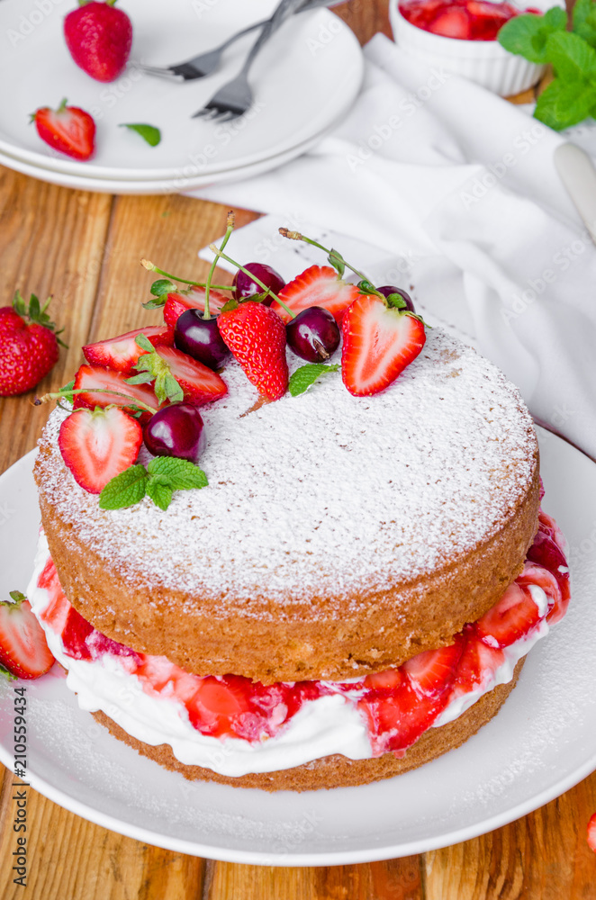 Victoria Sponge Cake with whipped cream and strawberry