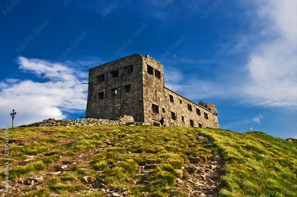 Ruins of the old stone observatory on the mountain peak Pip Ivan of the Chornohora range in the Eastern Carpathians in summer, Ukraine Ruins of the old stone observatory on the mountain peak Pip Ivan of the Chornohora range in the Eastern Carpathians in summer, Ukraine