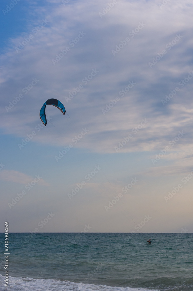 kitesurfer rides a kite-surf on waves of the sea kitesurfer rides a kite-surf on waves of the sea