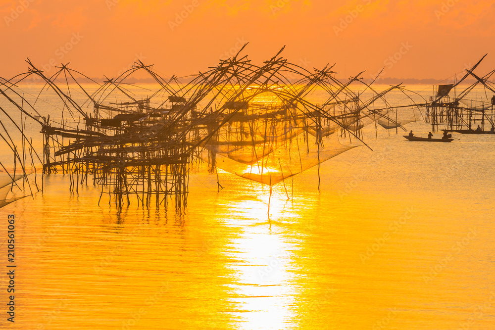 golden sky above fishing trap in Pak Pra Talay Noi sea Phatthalung south of Thailand