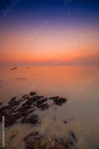 Colorful sky on beautiful beach at sunrise timing located at south of Thailand