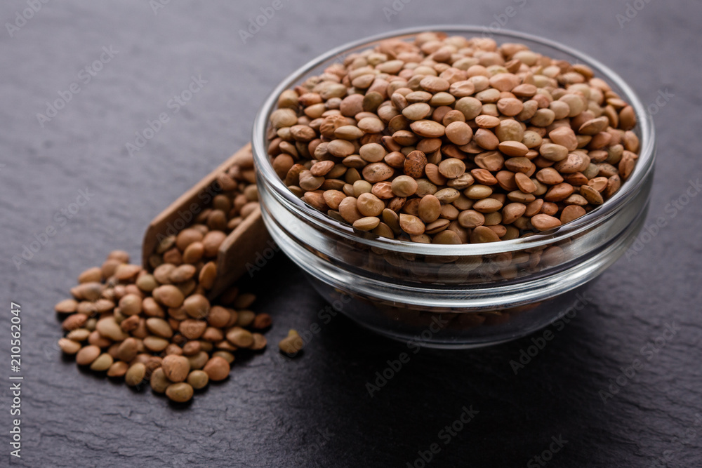 raw lentils on a dark stone background raw lentils on a dark stone background