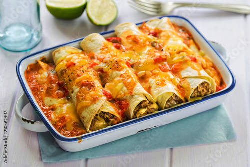 Beef enchiladas with tomato sauce and cheese photo